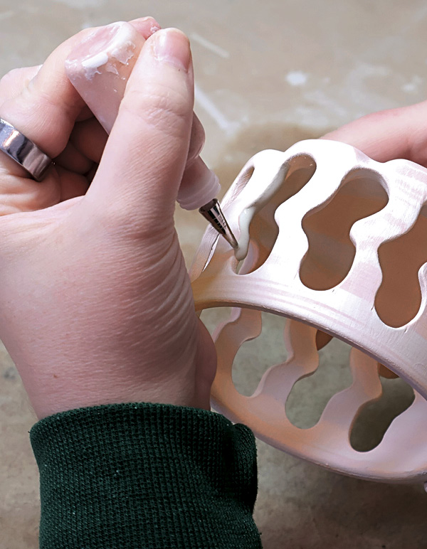 13 Use a slip trailer to outline the carved openings with glaze.