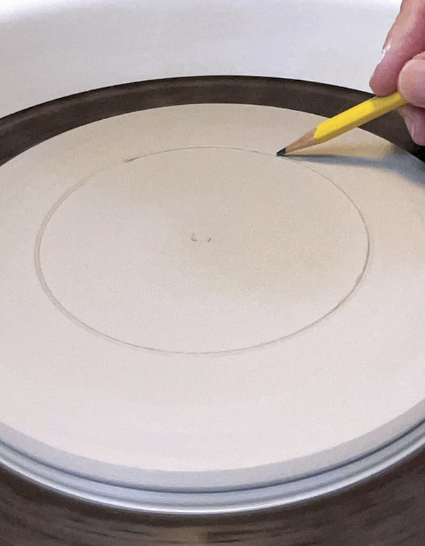 1 Throw a disk of clay, smooth with a steel rib, and mark off the image area.