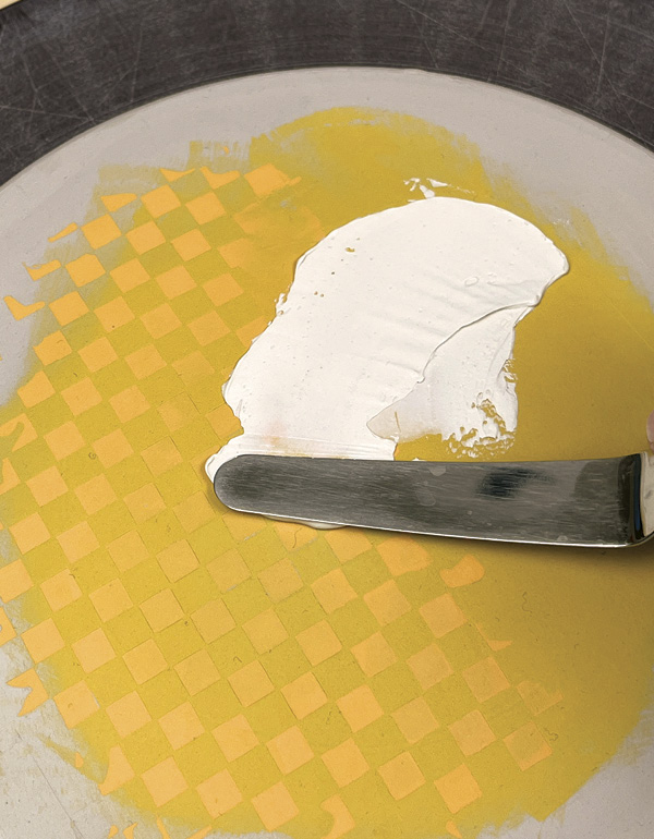 7 Spread white underglaze across the surface for placement of the image plate.