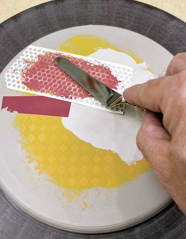 11 Place perforated drywall tape and spread red underglaze over it.