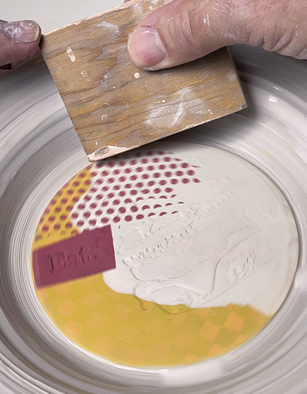 21 Start the wheel using a slow rotation, press the molding against the clay.