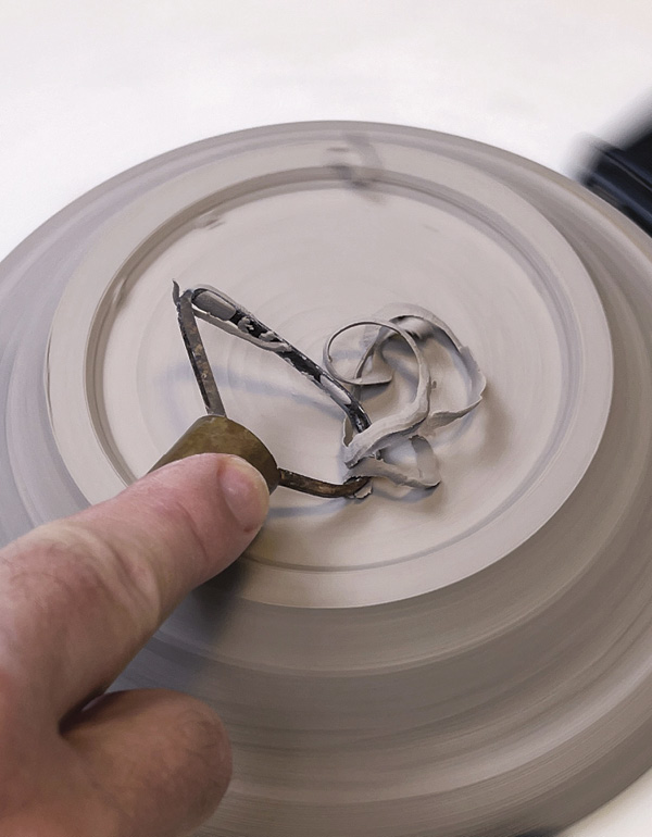 22 Center the plate upside-down and trim to define a traditional raised foot.