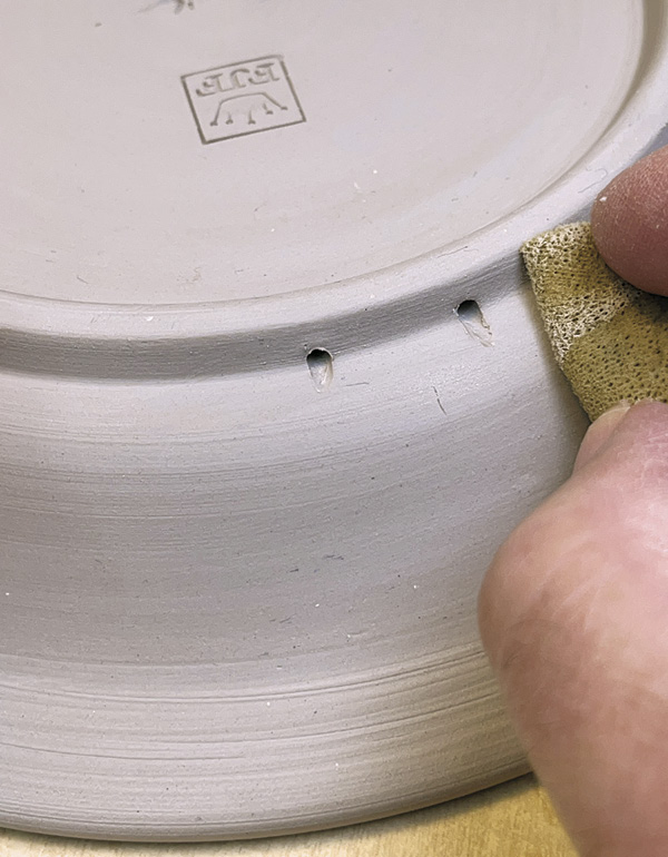 25 Brush away shavings and clean area with a sponge. Dry and bisque fire.