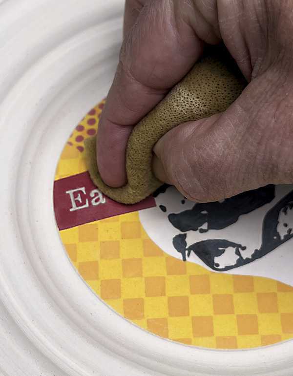 29 Wipe away any excess underglaze with a sponge on the image and letters.