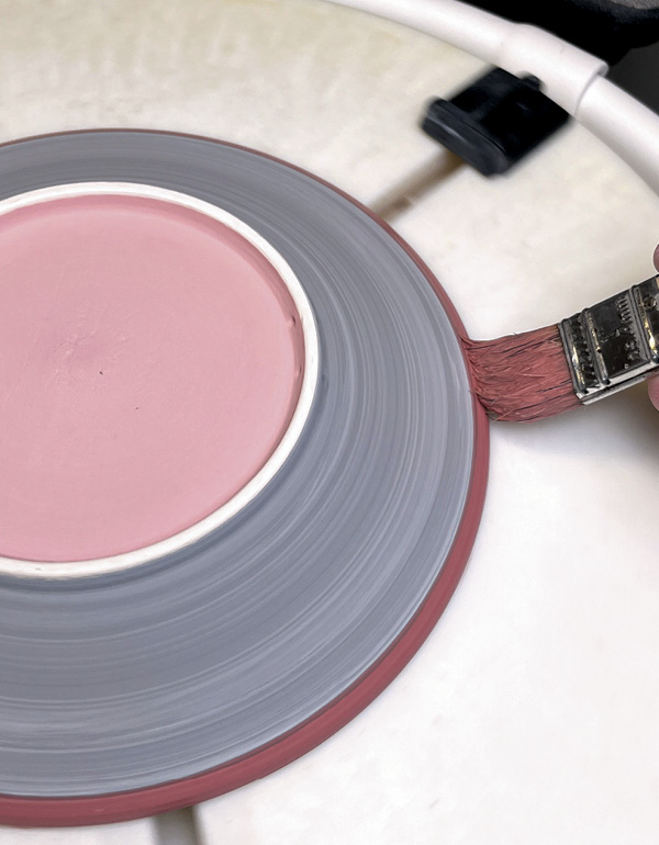 31 Brush several coats of red glaze onto the rim.