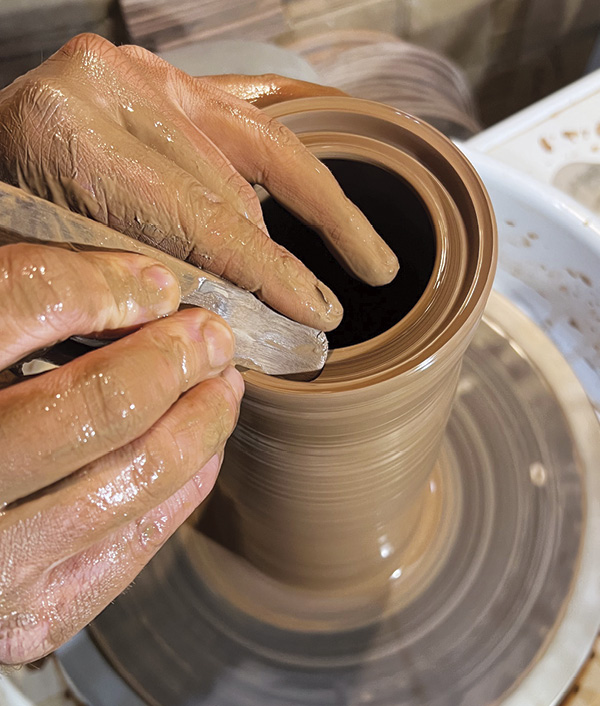 1 Split the lip using a wooden pottery knife to make a deep and sturdy gallery for the lid and cone to sit on.