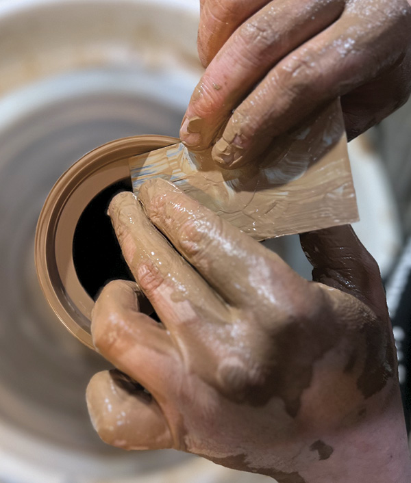 2 Use a rectangular metal rib to clean and square up the gallery. Angle the square rib out slightly to avoid the lid binding.