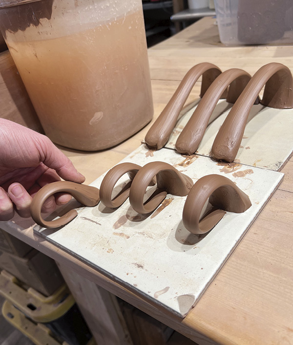 15 Shape, then allow the handles to firm up while you work on the spout. Always pull more handles than you need.