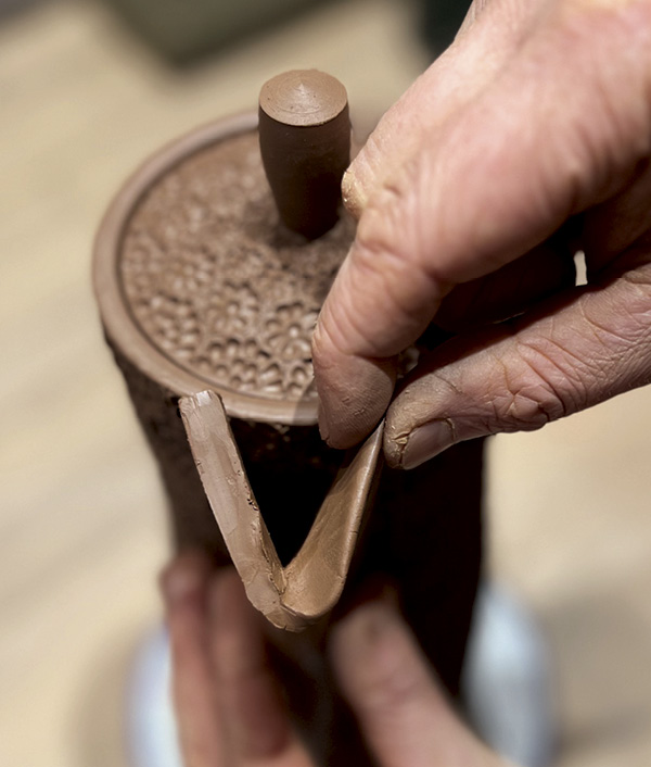 16 Fold a slab in half lengthwise and taper. Pinch the top 1/2 inch from the pot side working out to elongate the spout.