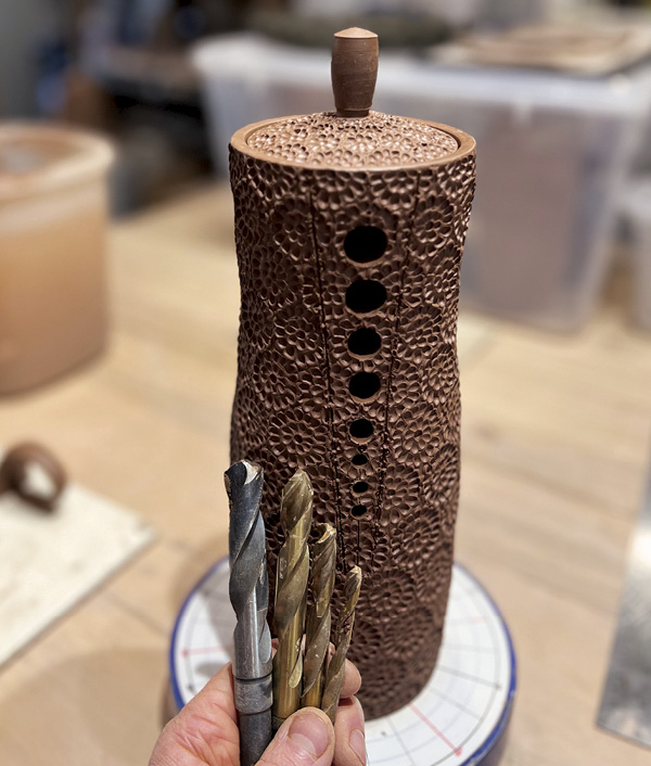 17 Use drill bits of tapering sizes from ¾ inch down to ¼ inch to open the pot body to the spout.