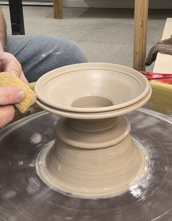 5 Throw the vase top off a larger hump of clay and measure it to fit the base.