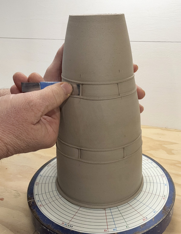 7 Press rigid square edges into the surface of the clay for vertical lines.