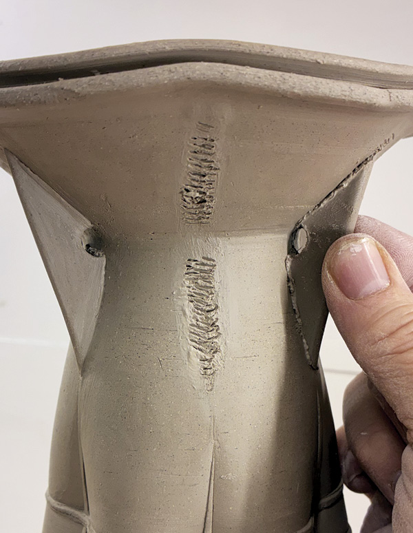 14 Score, attach, and align the buttresses with the vertical ridges on the vase.
