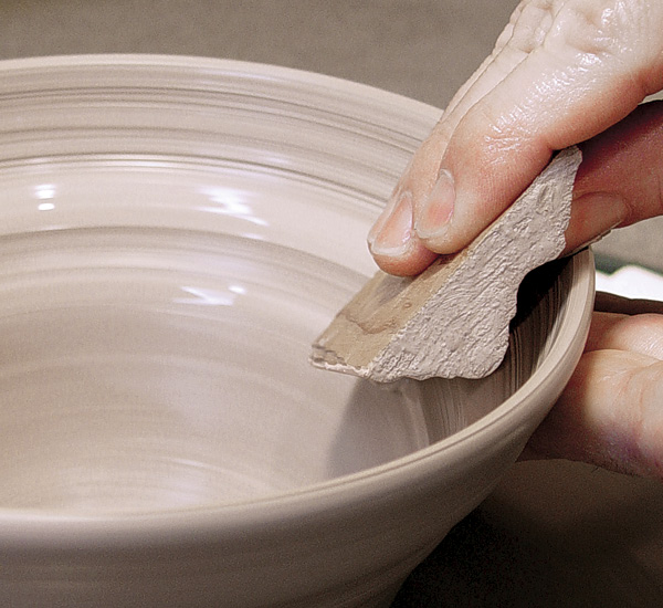 2 Press the molding into the rim while supporting the outside.