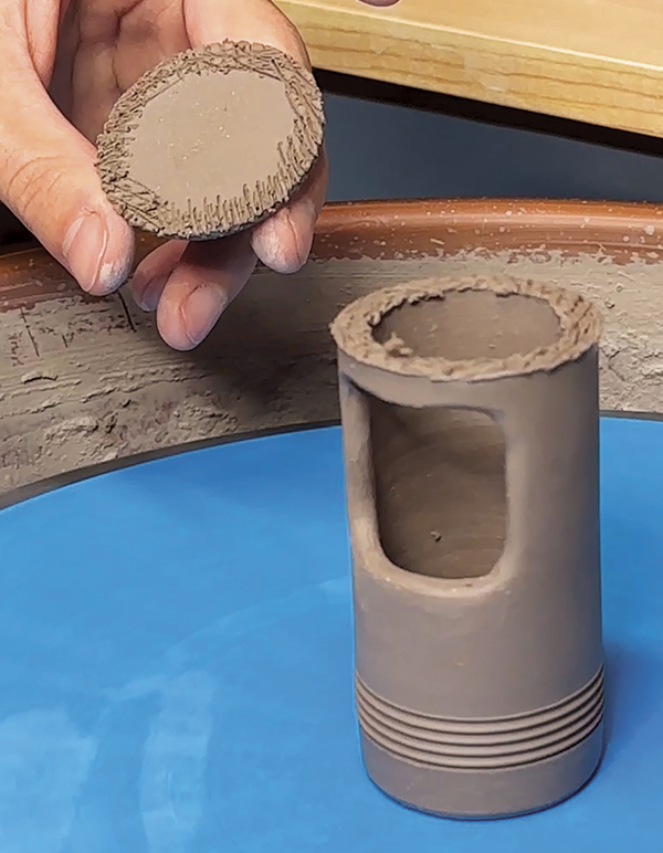 8 Score and attach the disk and finial to the top of the first thrown cylinder.