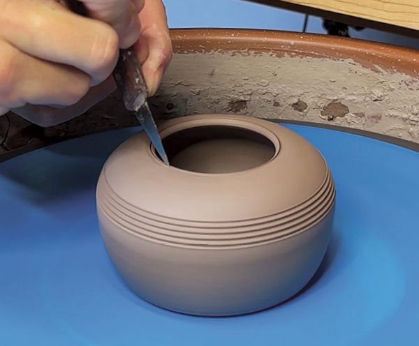 11 Trim the foot of the base form and cut off any excess clay at the rim to allow the second cylinder to fit into it like a lid.