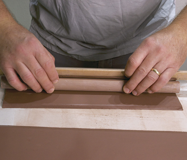 1 Roll the clay slab around the dowel, making sure to not wrap it too tight. Bevel the edges for the attachment.