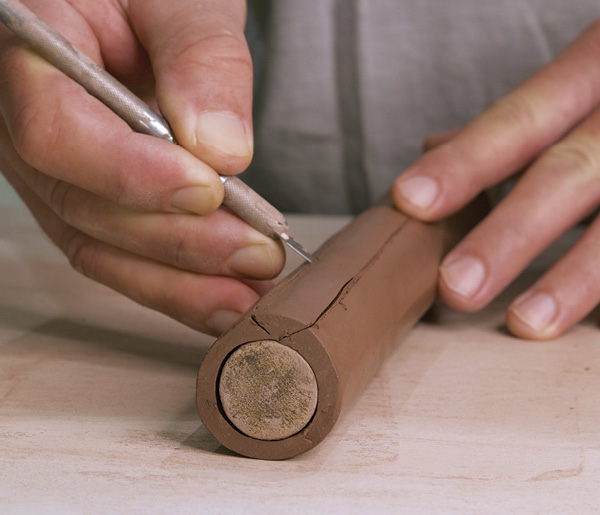 3 Cut the cylinder open with beveled edges, making an area where a second cylinder can attach to it.