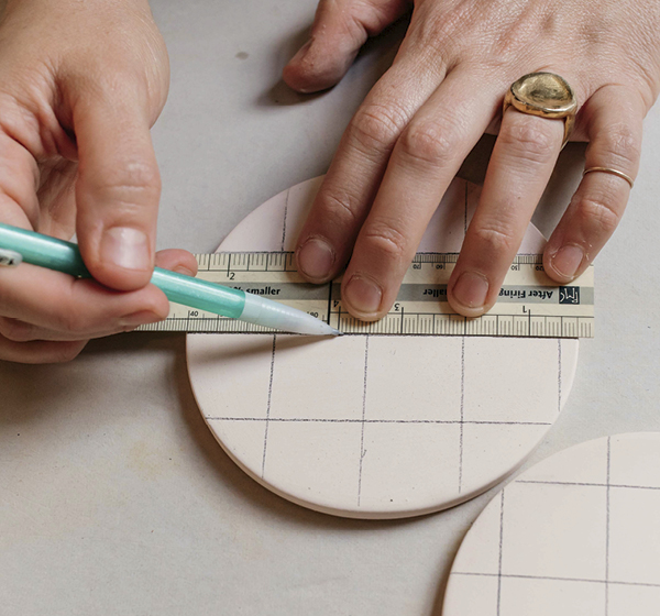 2 Sketch designs onto the bisque surface with a pencil.