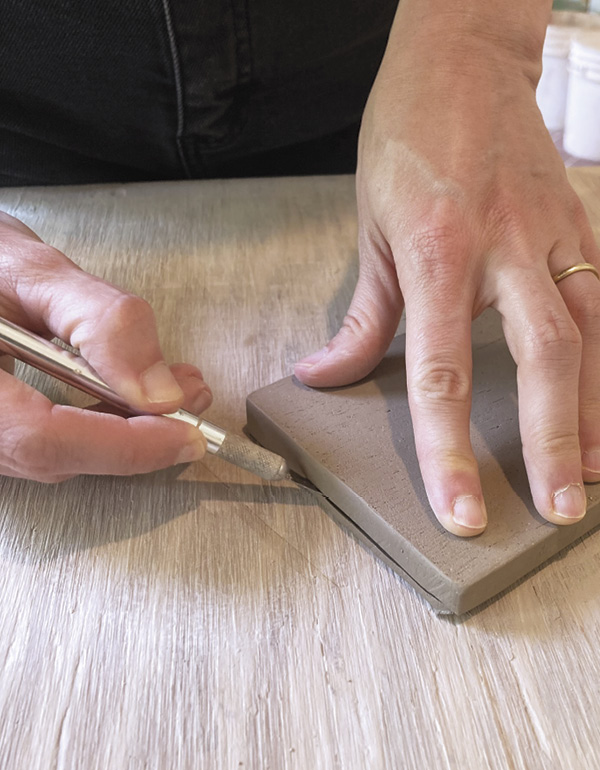 3 Once leather hard, cut a bevel on the underside of your slab.