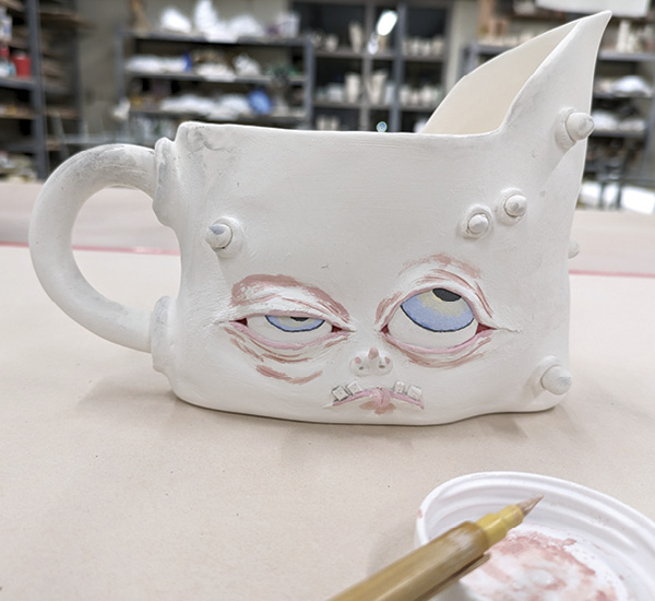 12 Build up color by adding layers of underglaze in and around the eyes.