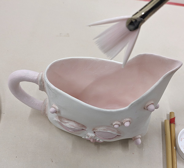 13 Use a fan brush to apply glaze to the interior of the pot.