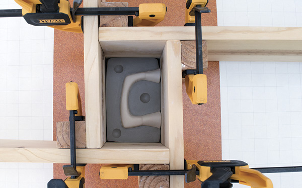 4 Cut mold keys into the slab, then build a mold box using cottle boards and clamps connecting each corner.