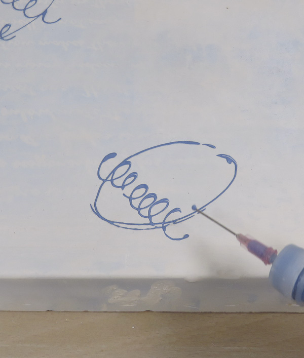 4 Start with the blue slip trailer to add patterns over the plaster. Looped lines are my favorite marks to make.