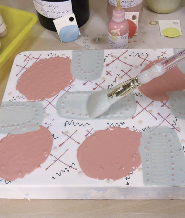 7 Build areas of color on top of the slip-trailed patterns. Try to use contrasting colors so the slip-trailed lines stand out.