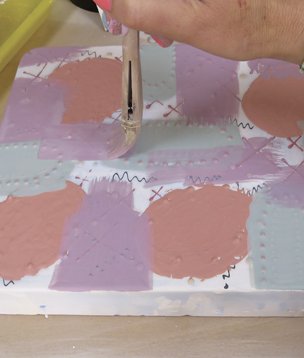 8 Fill in any further spaces in the background with another slip color and leave some areas uncovered.