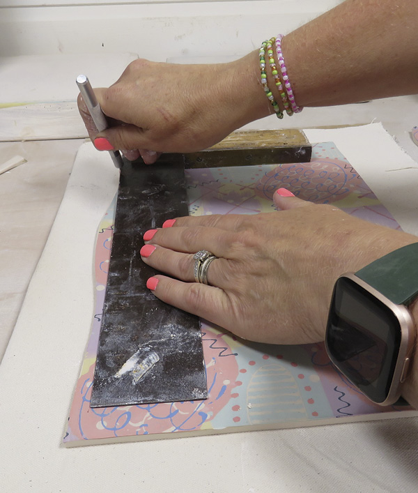 13 Trim the edges of the slab to create a rectangle using a right-angle tool. Keep the trimmings to create extra pieces.