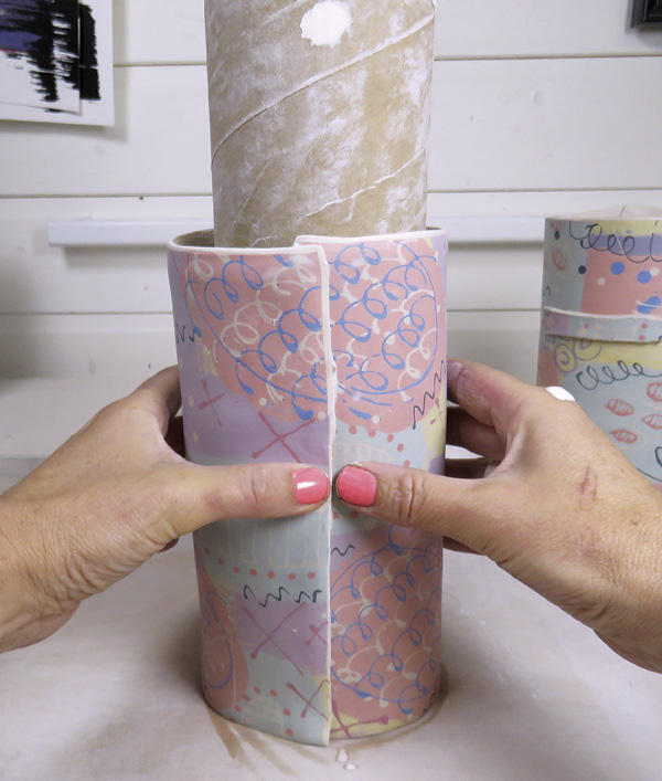 14 Overlap and join the edges of the slab to create a vessel shape, using a cardboard tube for stability.