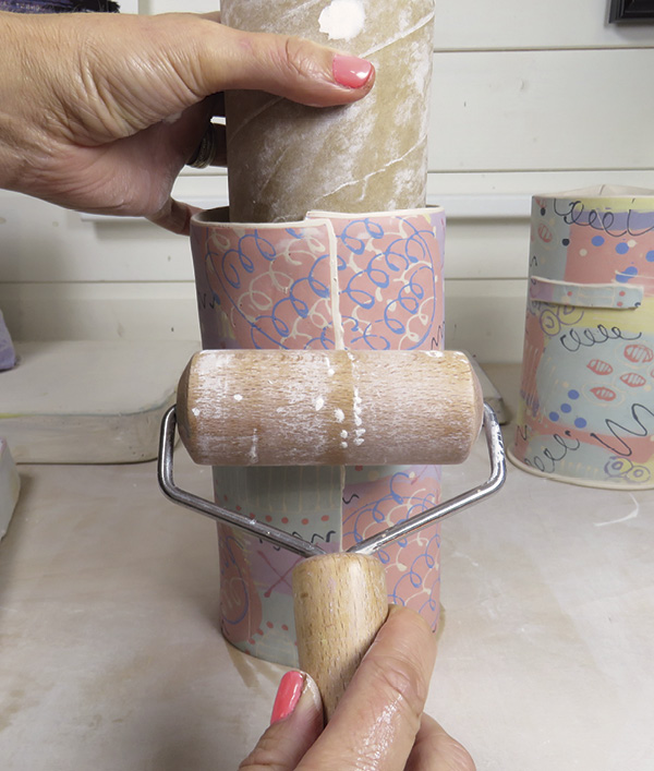 15 Secure the overlapping join using a pony roller, pressing firmly against the clay and the cardboard tube.