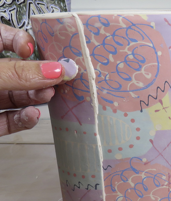 17 Allow the slip to dry fully before cutting and fettling the base. Add the buttons for added interest.