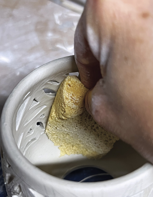 8 After making the cuts, use a damp sponge to smooth the interior wall.