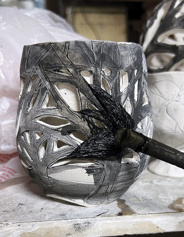 13 Brush black stain onto the outer wall to fill the carved branch drawings.