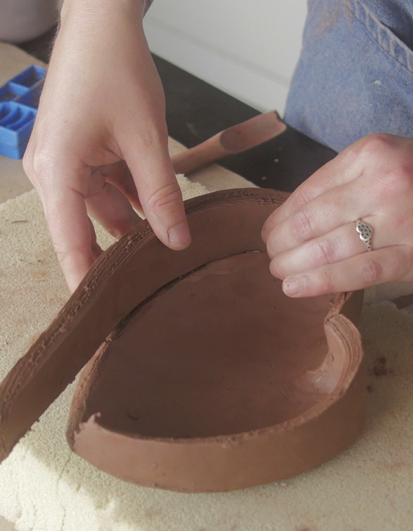 5 With the base sitting on foam, attach the walls to the base.