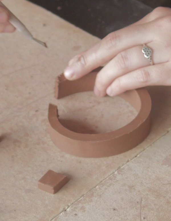 12 Cut a strip of clay to make a small ring for the lip around the opening.