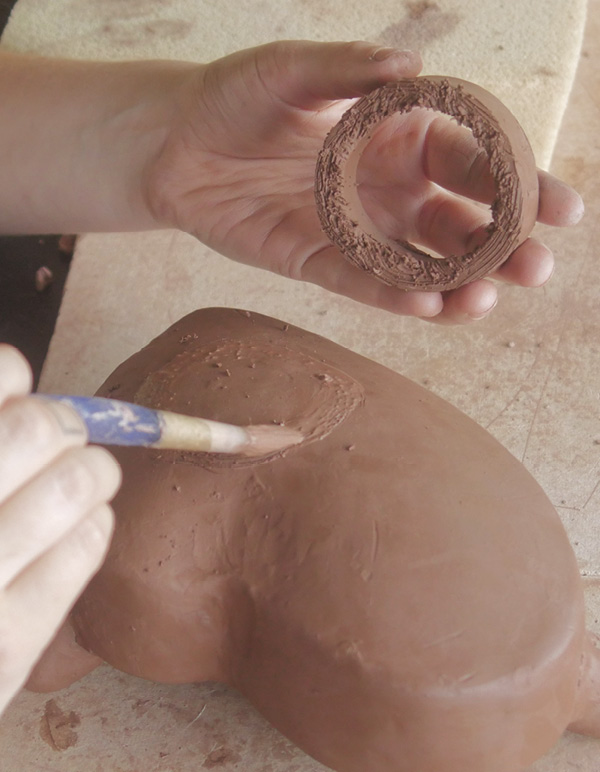 13 Slip and score the ring to the base and then make sure it is level.