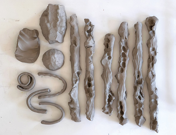 1 Create a variety of loosely sculpted components with the potential to become various parts of a candlestick.