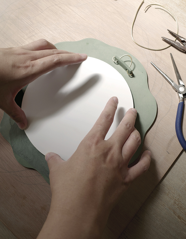 15 Thread annealed brass wire through the tabs for hanging.