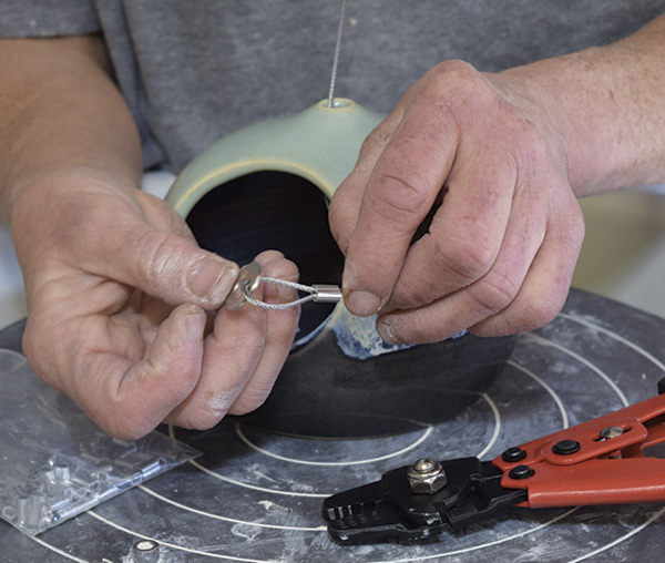 9 For the loop on the inside, thread a bead or washer onto the loop to prevent the crimped loop from pulling through the hole when you hang the bird feeder.