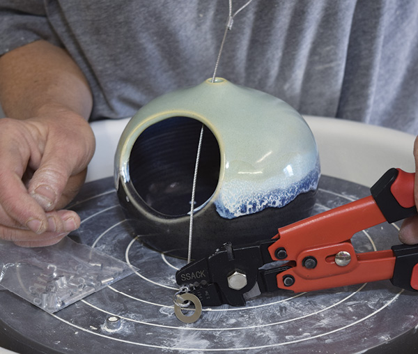 10 Squeeze the crimping tool on the crimp to finish the inner loop. Your bird feeder is now ready to hang.