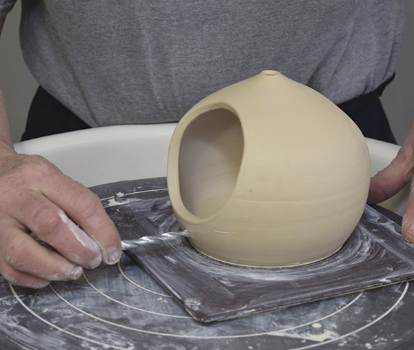 11 Optionally, after cutting the opening circles, drill holes for perches, then insert a dowel through the hole during assembly.