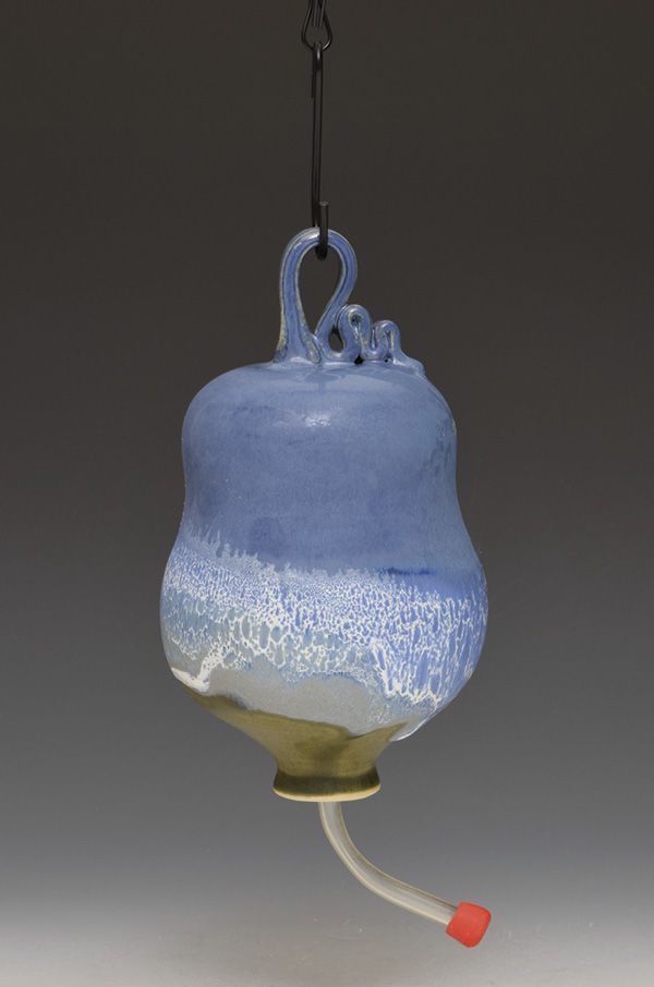 Sumi von Dassow’s hummingbird feeder with feeder tip, 6 in. (15.2 cm) in height, wheel-thrown white stoneware, fired in oxidation to cone 6. Notice that the feeder was glaze fired standing on the rim.