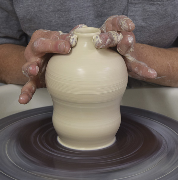 2 Collar the rim in to make a narrow neck. Test fit the feeder tip in the opening. The widest part of the feeder cork should barely fit the narrowest part of the opening, if your clay shrinks about 12.5%.