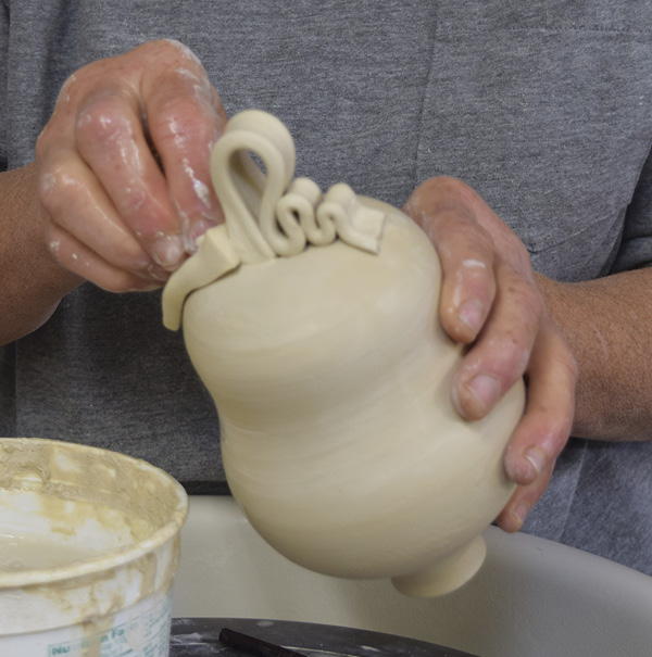 8 Loop the handle around and create a few extra loops for decoration.