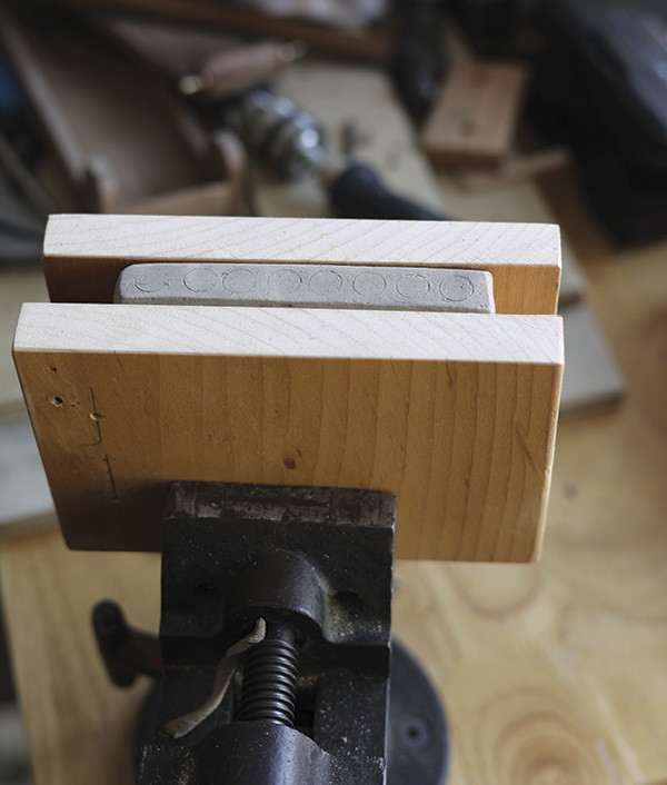 8 Line a vise with smooth, flat wood to support the clay.