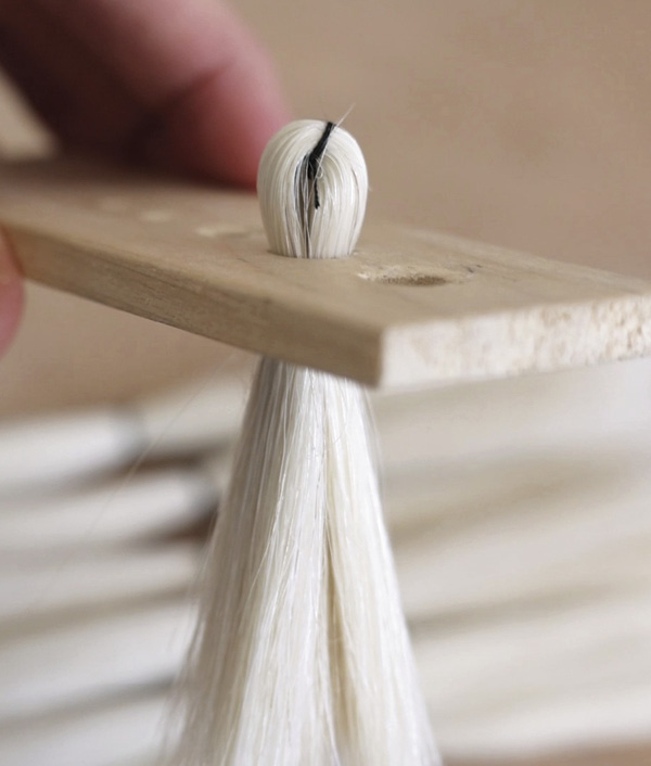 12 Fold the fiber in half and check the fit in the hole gauge.