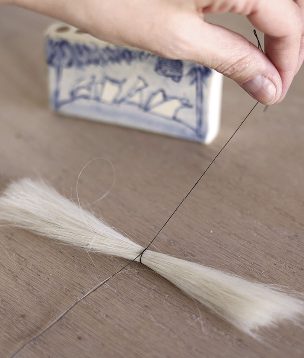 13 Tie thread around the midpoint of each bundle.